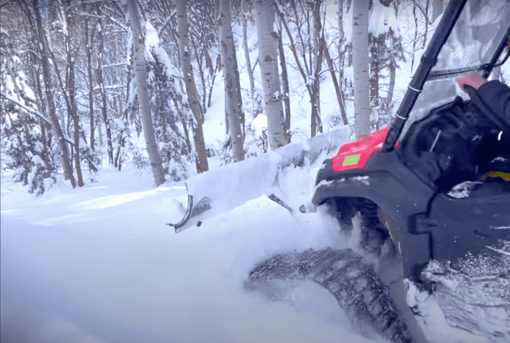 Honda Pioneer with tracks pulling a snow groomer